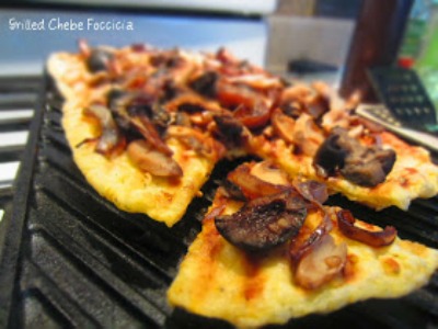 Grilled Chebe Focaccia with Black Olives Mushrooms and Balsamic Onions